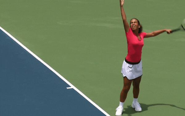 Girl Serving Tennis Ball